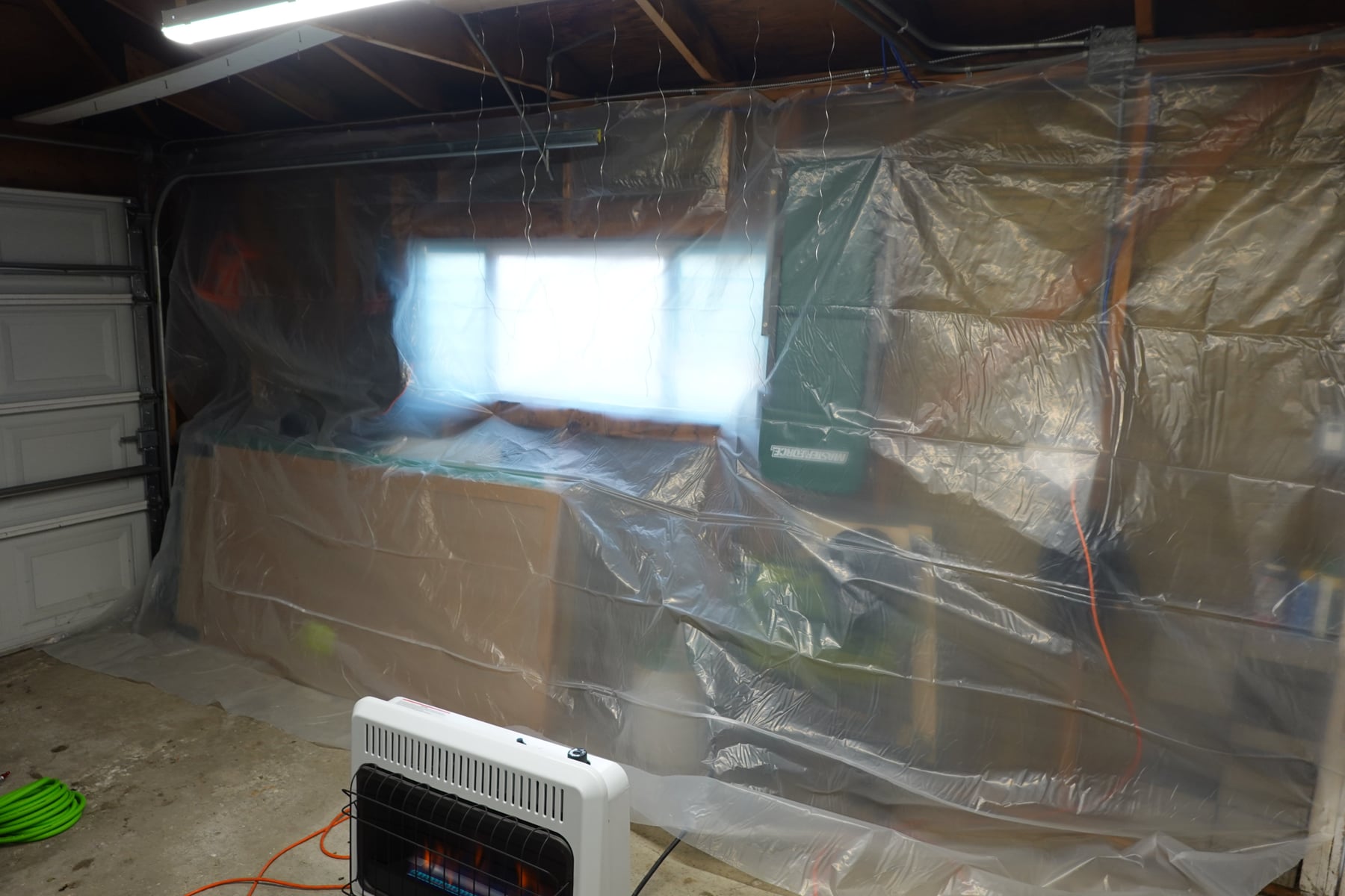 The paint wall and heater in the garage.