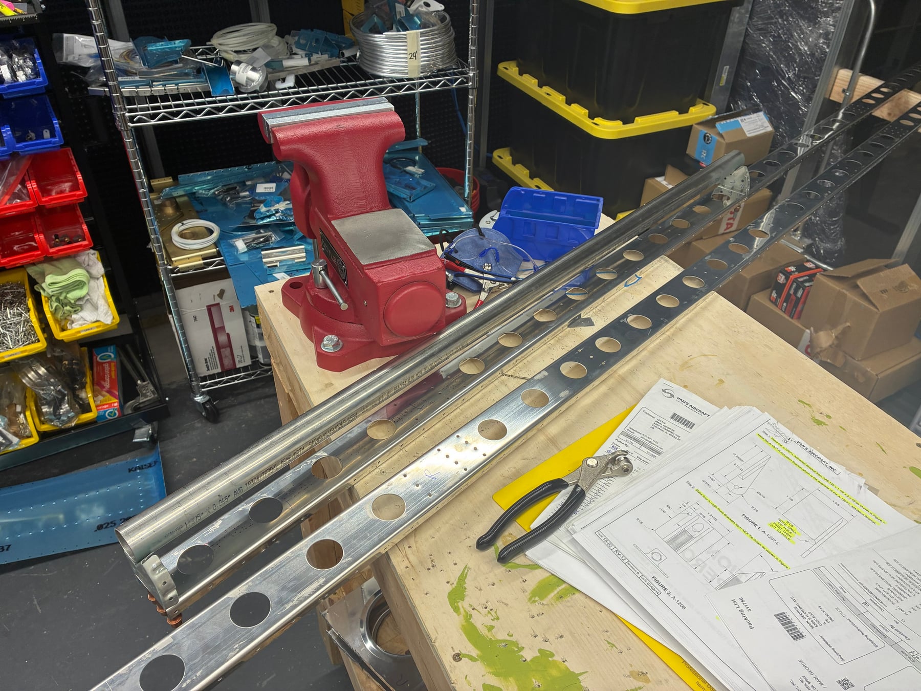 Working on the flaperon counterbalances while deburring of the wing ribs is happening.